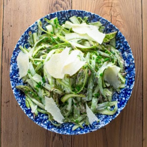 shaved asparagus in a creamy dressing garnished with parmesan shavings.