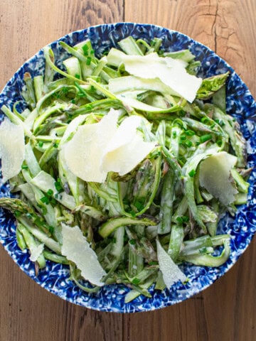 shaved asparagus in a creamy dressing garnished with parmesan shavings.