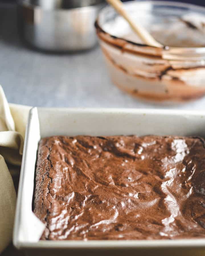 Baked brownies uncut in metal baking pan