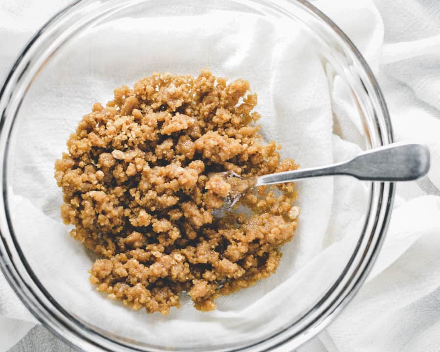 Prepared streusel topping in glass bowl with a fork