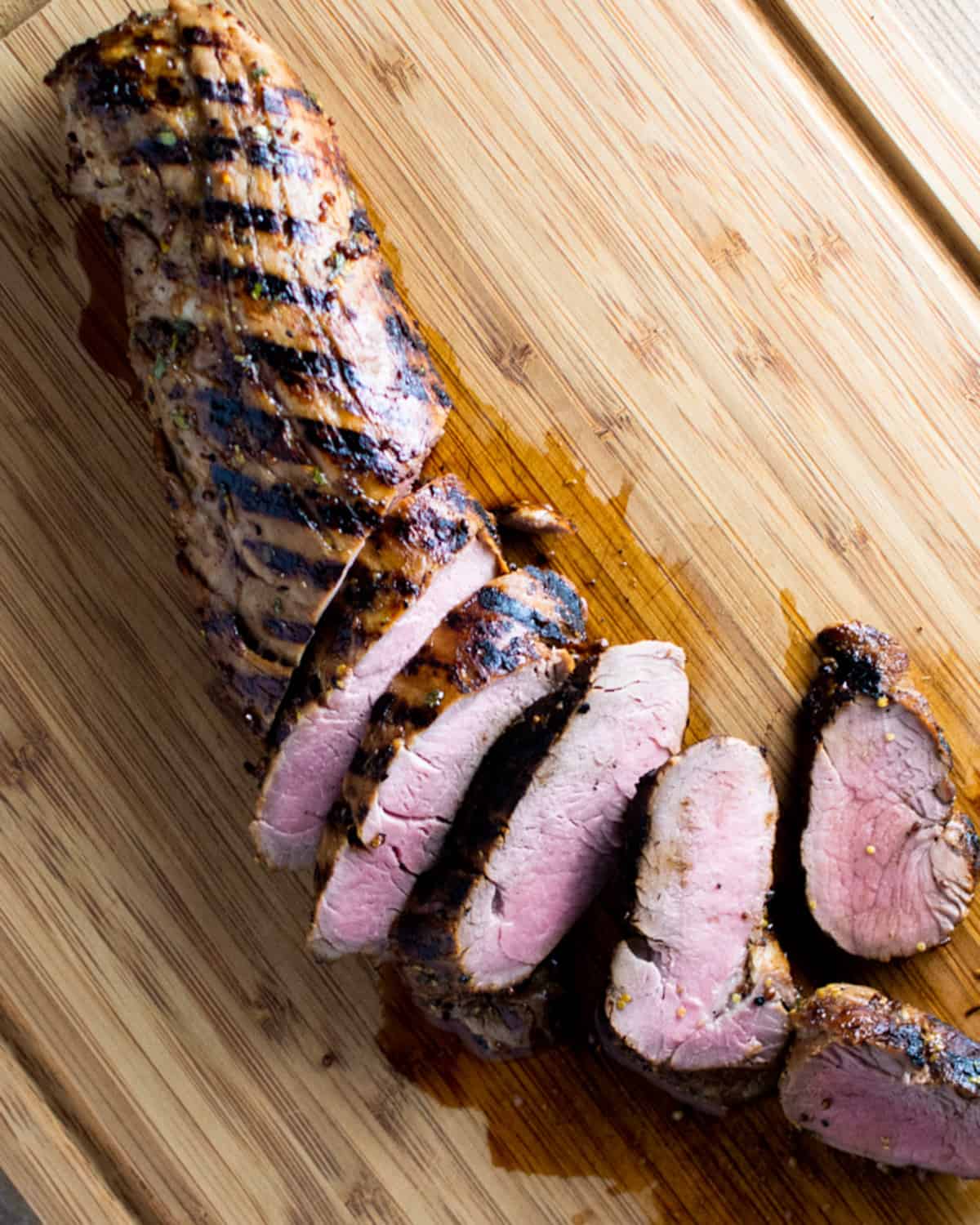 Partially sliced tenderloin showing the slight pink color after cooking. 