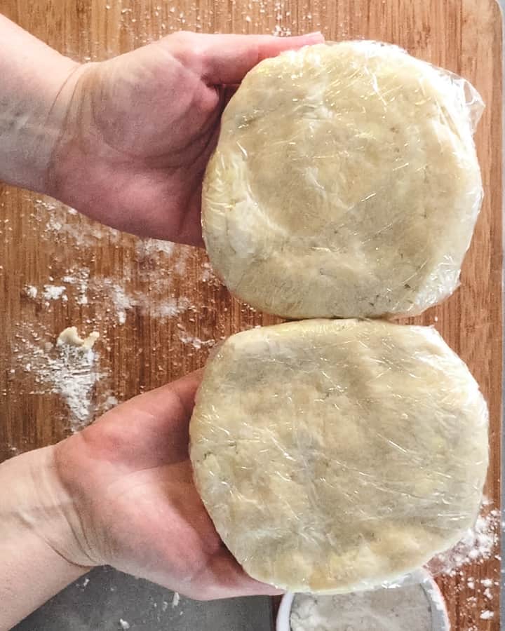 two disks of dough wrapped in plastic wrap