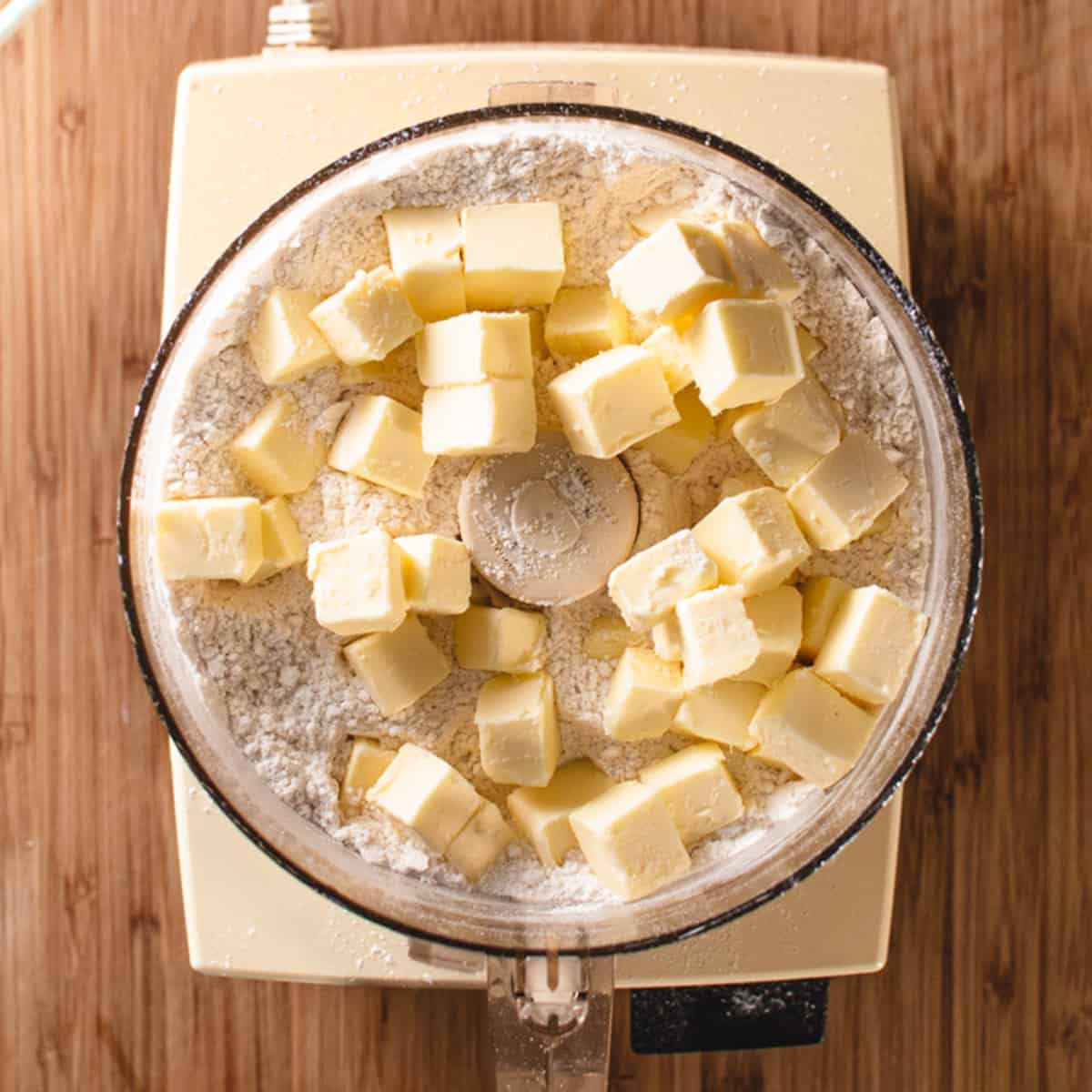 Food processor with butter and dry ingredients.