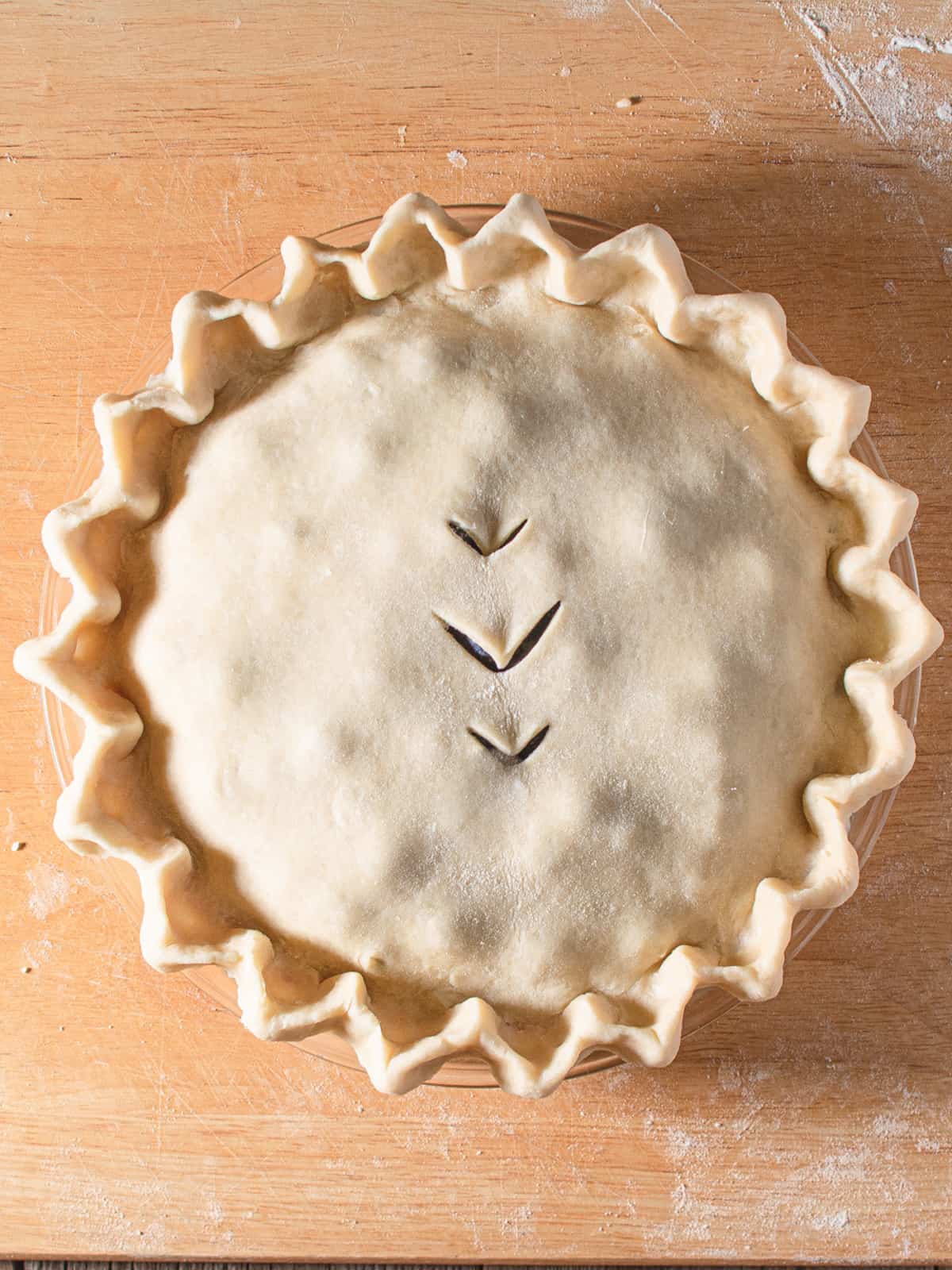 double crust pie with fluted edges before baking.