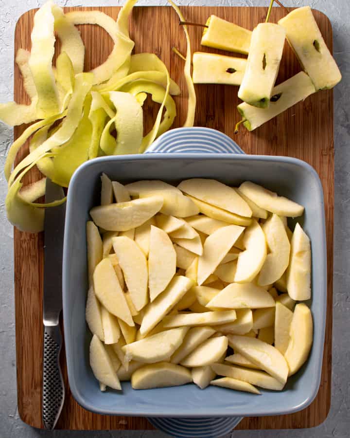 raw sliced apples in prepared square baking dish