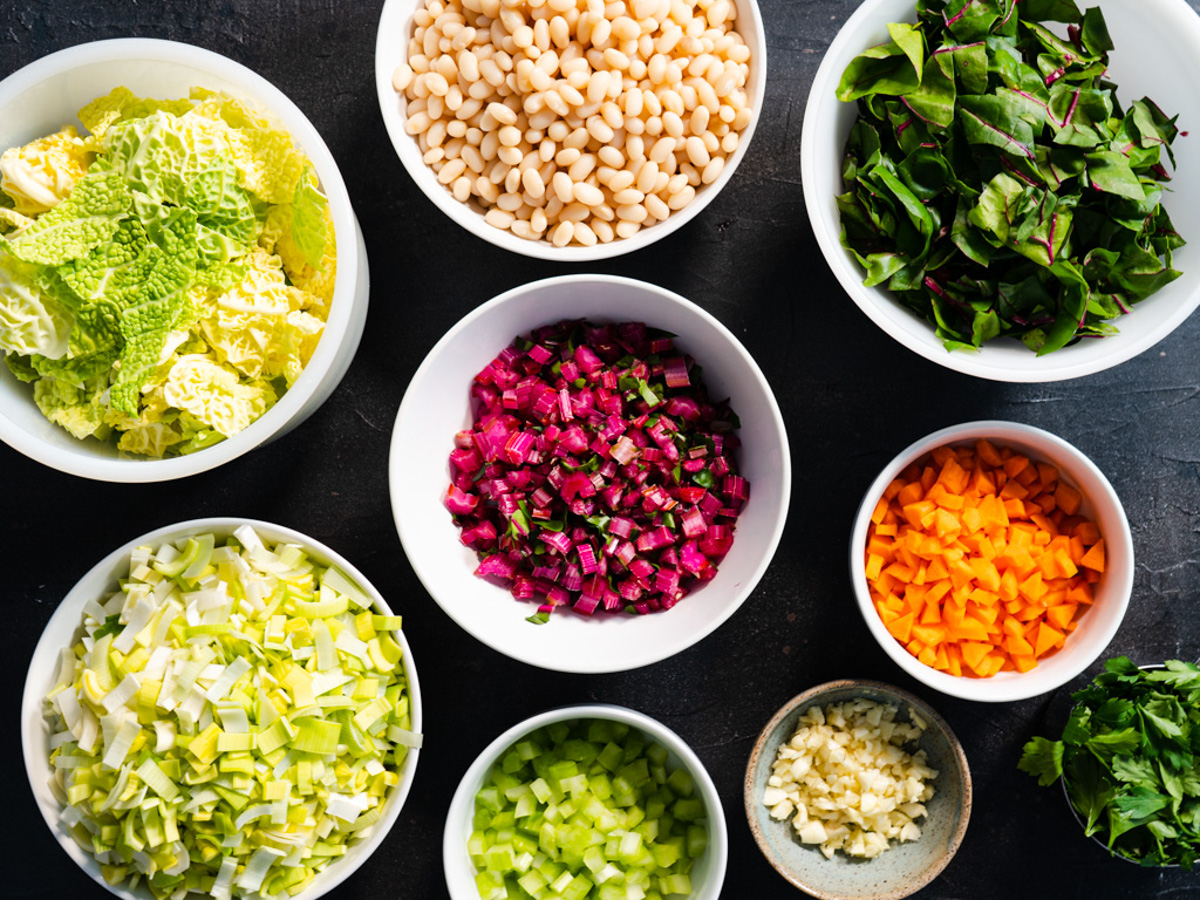 ingredients for soup in separate bowls.