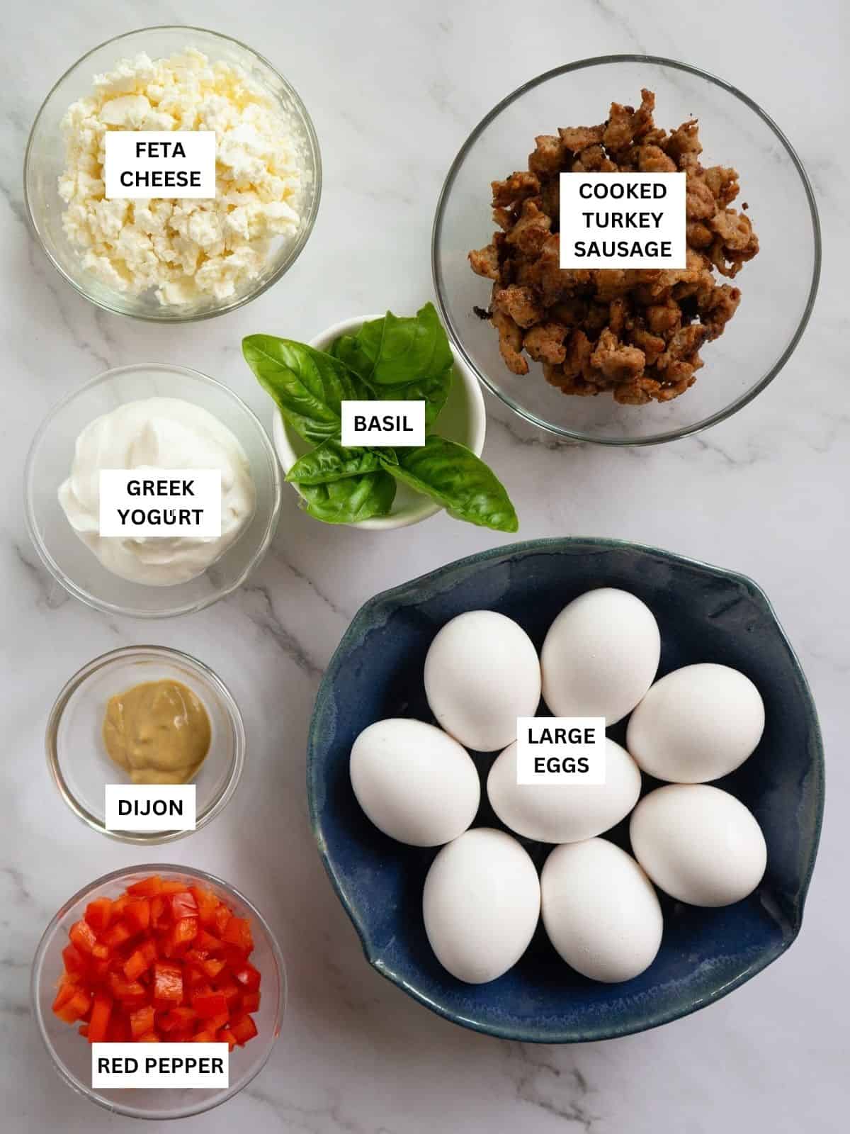 All ingredients to make egg bites laid out on a table with labels.