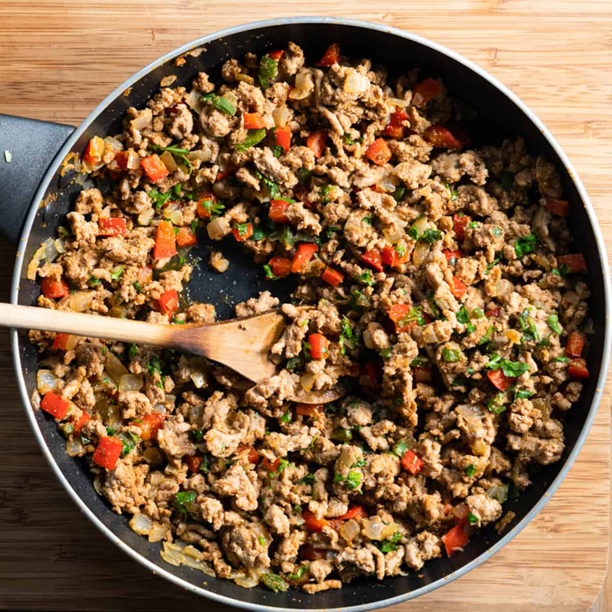 all of the taco stuffing ingredients in a frying pan after being cooked. 