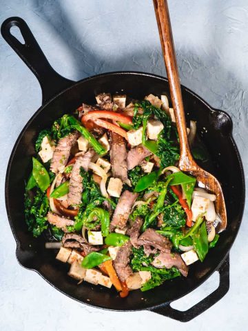 beef stir fry with broccoli rabe in cast iron skillet