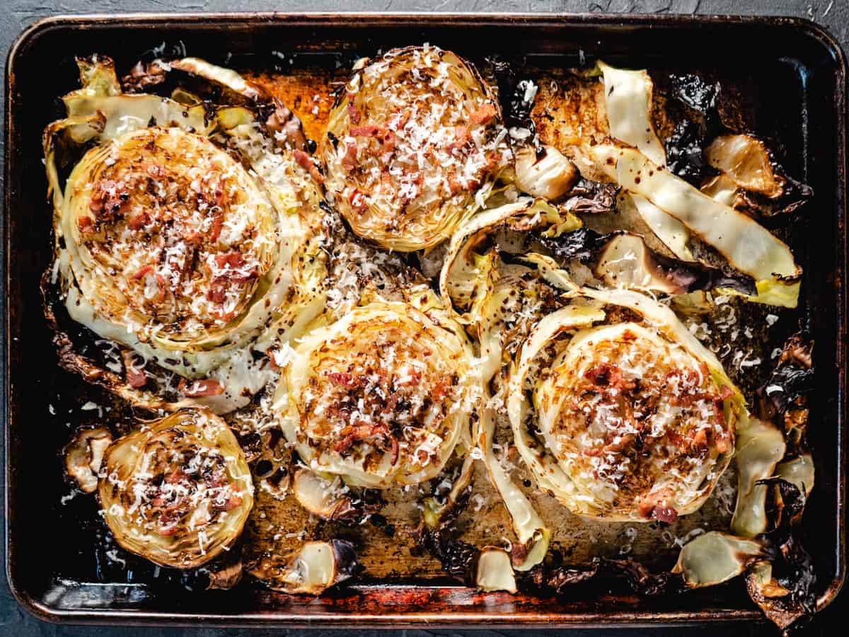 roasted cabbage steaks on a rustic baking sheet.