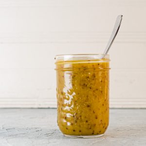 honey mustard dressing in a jar with a spoon