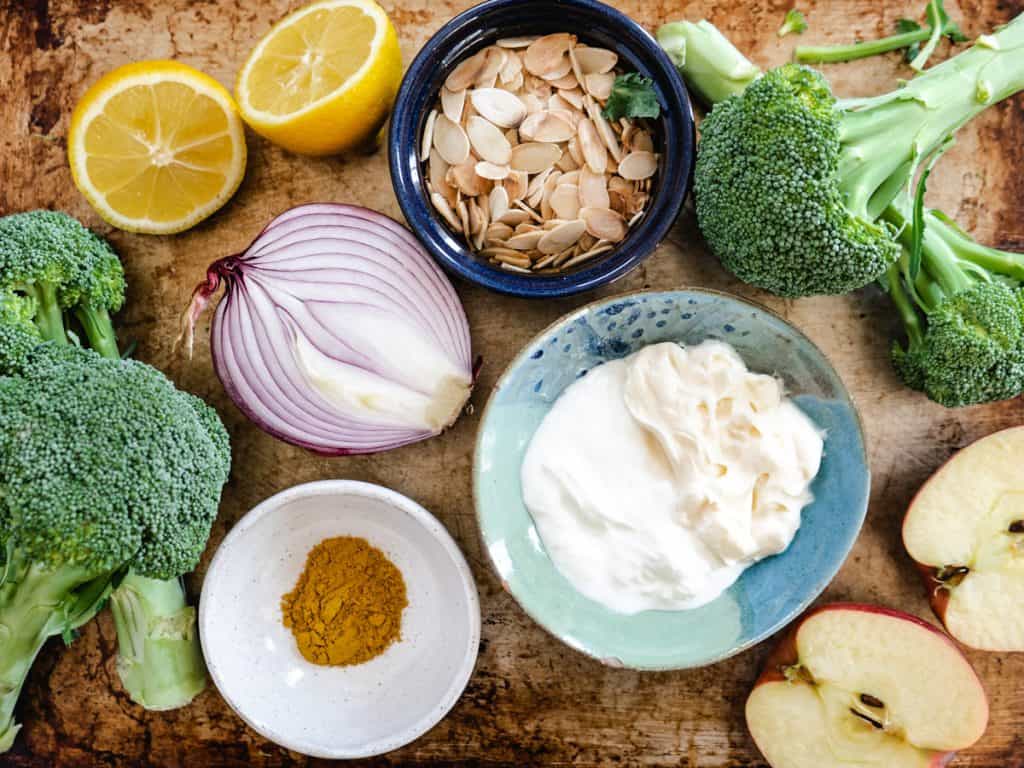 ingredients for roasted broccoli salad on rustic baking tray