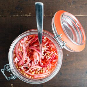 pickled onions in a jar with spoon