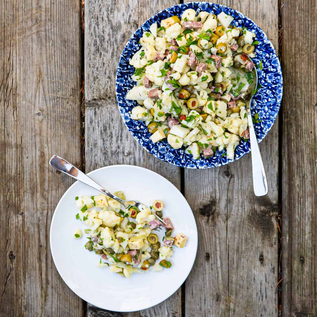 cauliflower salad in blue dish with side plate with individual portion 