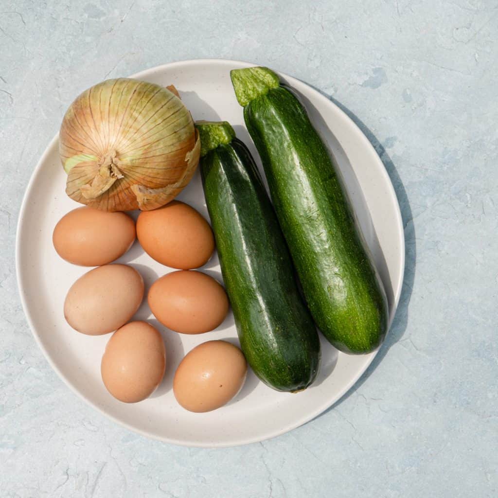 zucchini onion and eggs on white plate