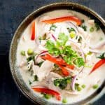 thai style coconut chicken soup in ceramic bowl