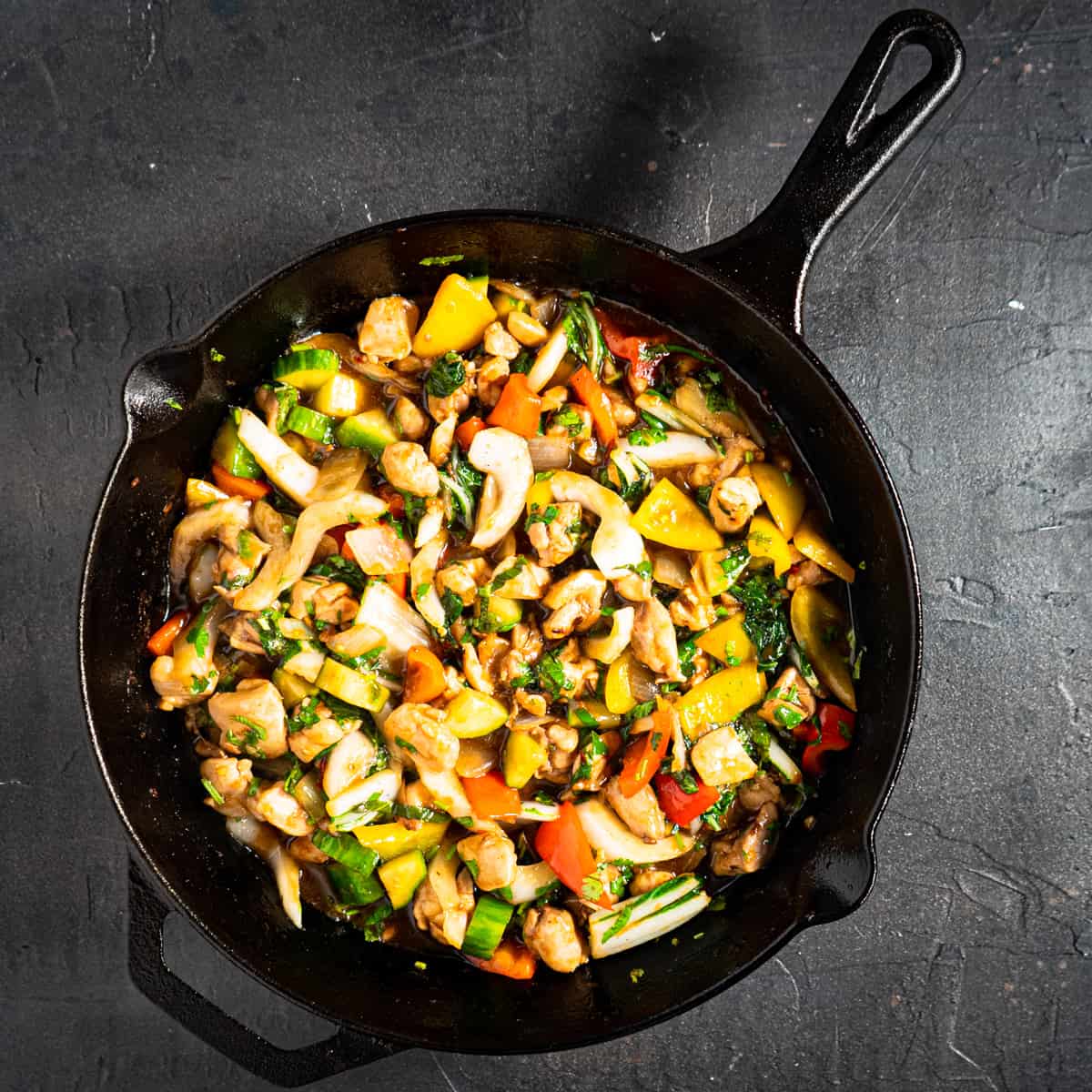 thai style chicken stir fry in cast iron skillet