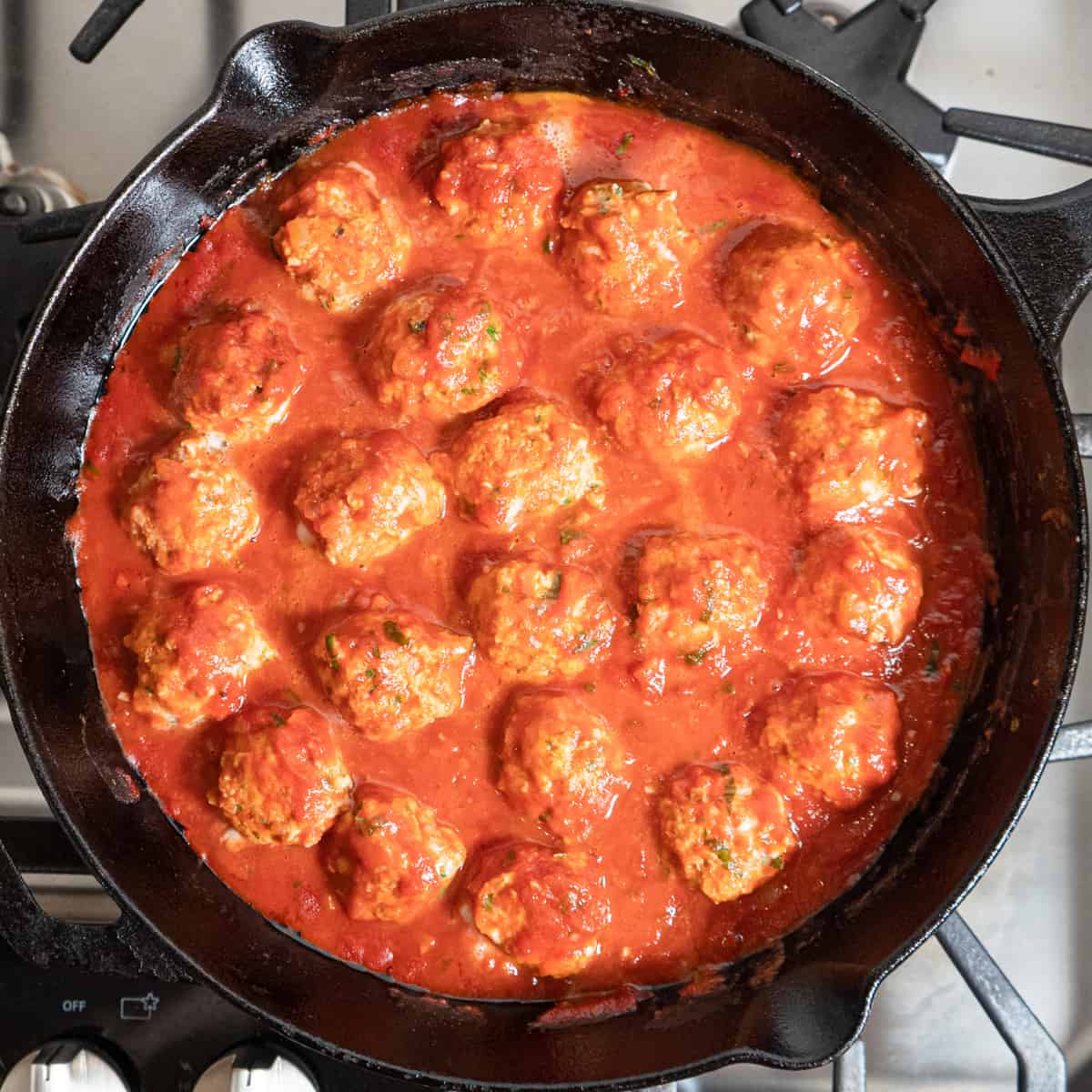 meatballs are flipped in the skillet