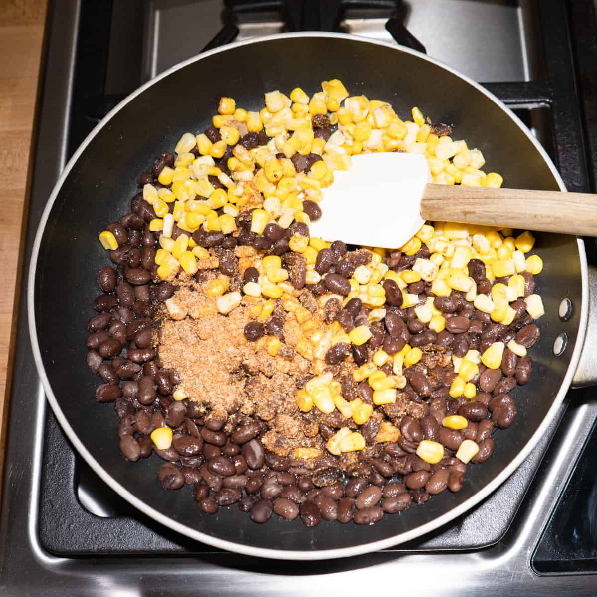 black beans, corn, and spice mix in a frying pan