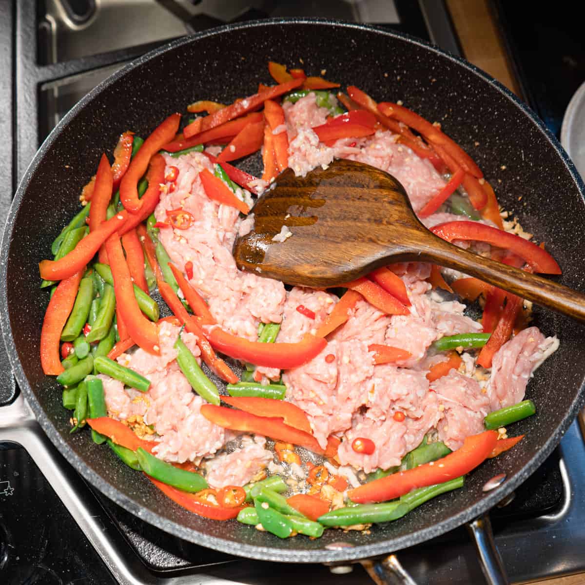 chicken, peppers, and beans added to the pan