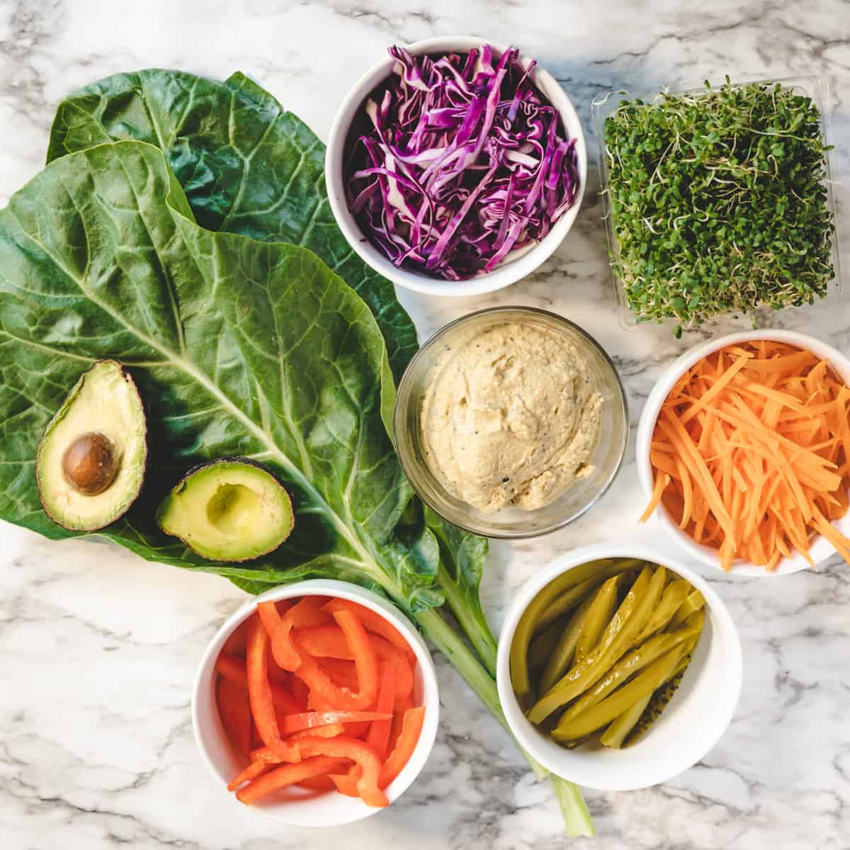 all prepared ingredients to make collard green wraps.