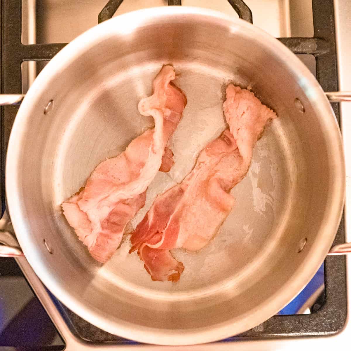 Bacon for bbq sauce cooking in a saucepan. 