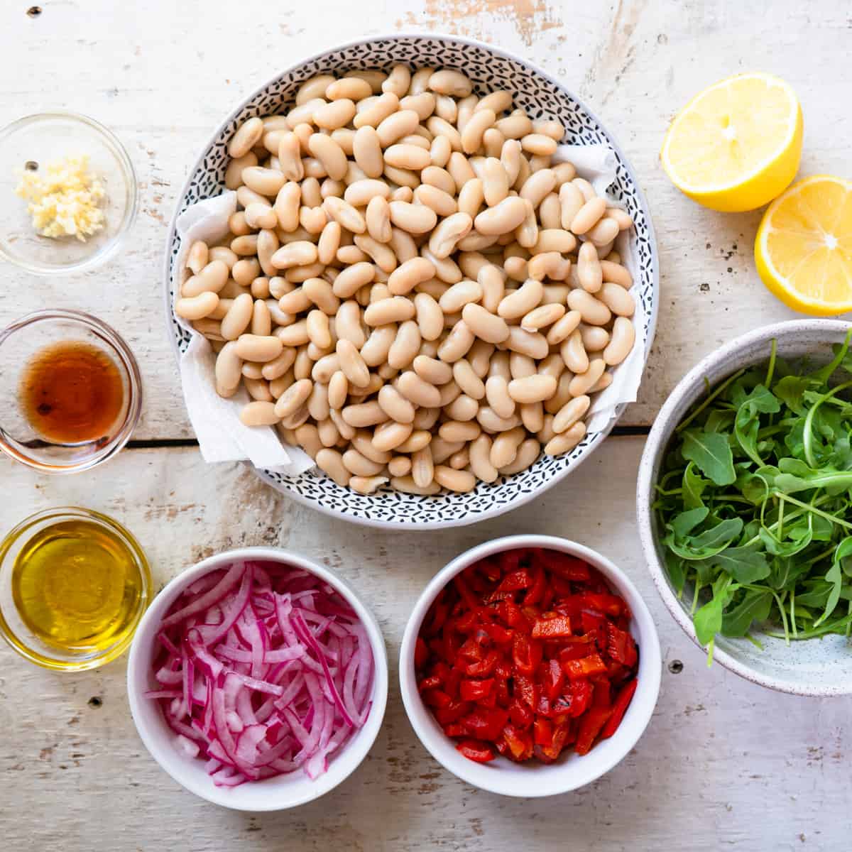 all prepared ingredients to make white bean salad.