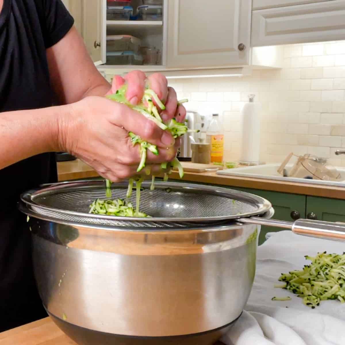 Squeezing out water by hand and placing on a kitchen towel.