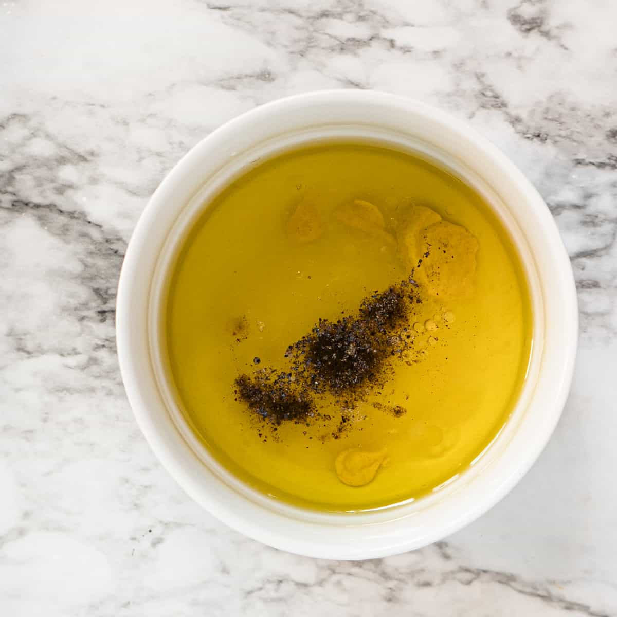 vinaigrette ingredients in a white bowl.