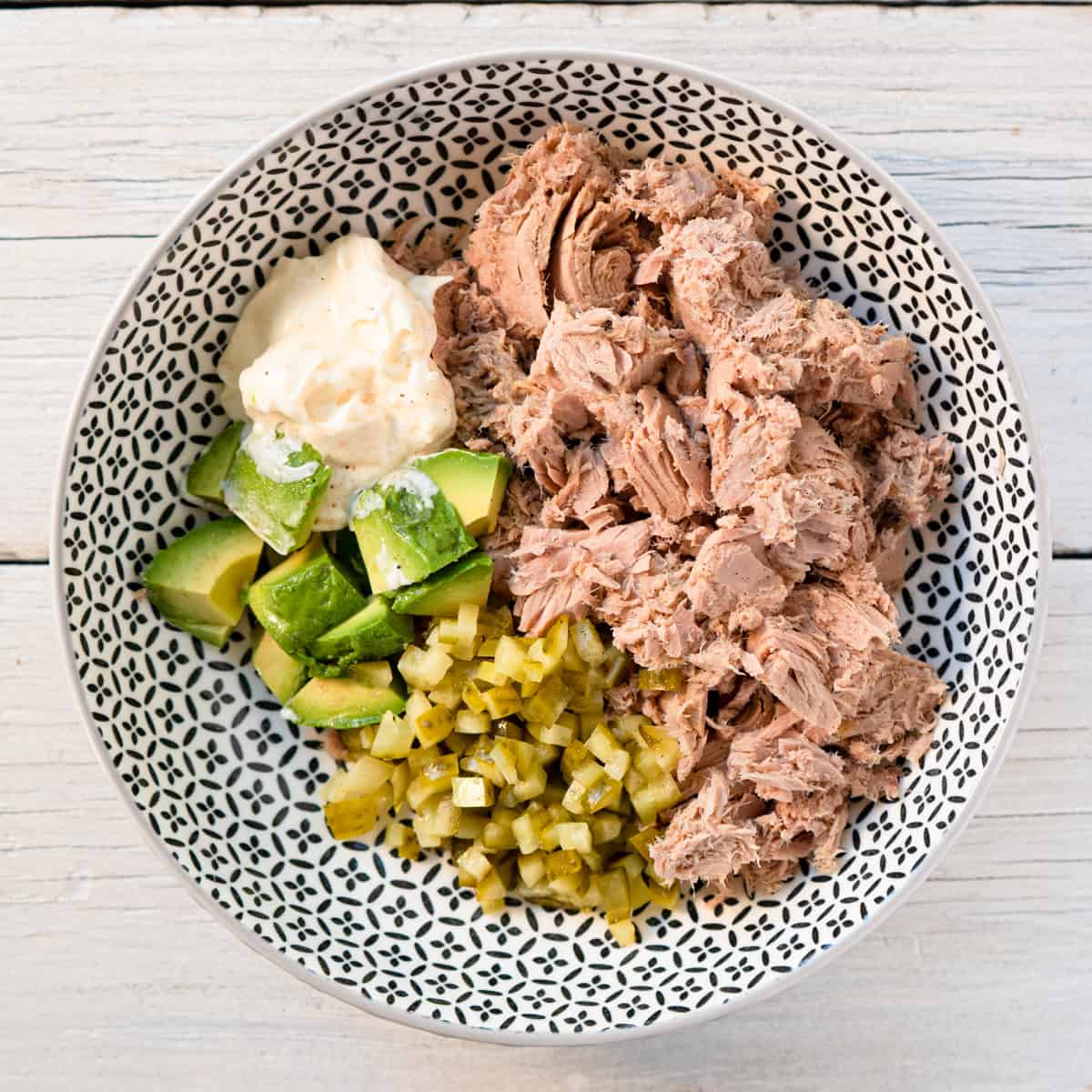 all ingredients for tuna salad in a bowl before mixing. 