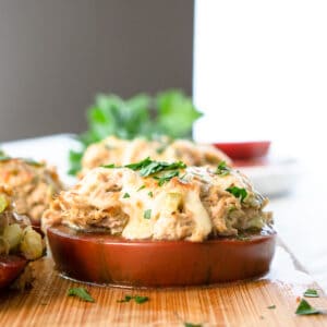 baked thick slice of tomato topped with tuna salad and melted cheese.