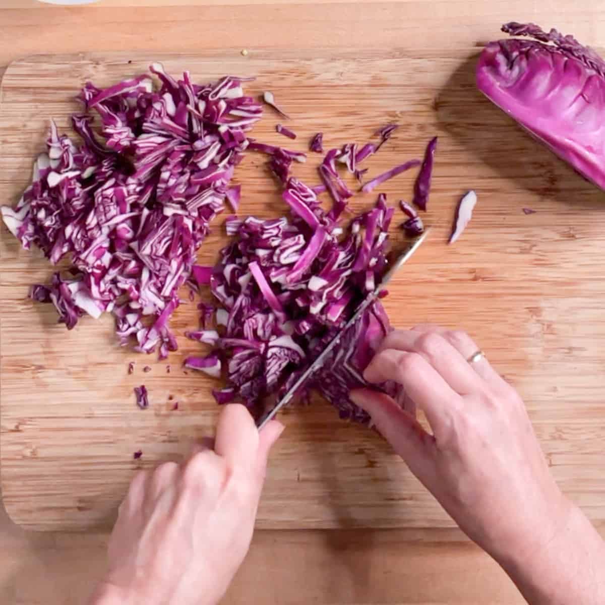slicing red cabbage with a chef's knife..