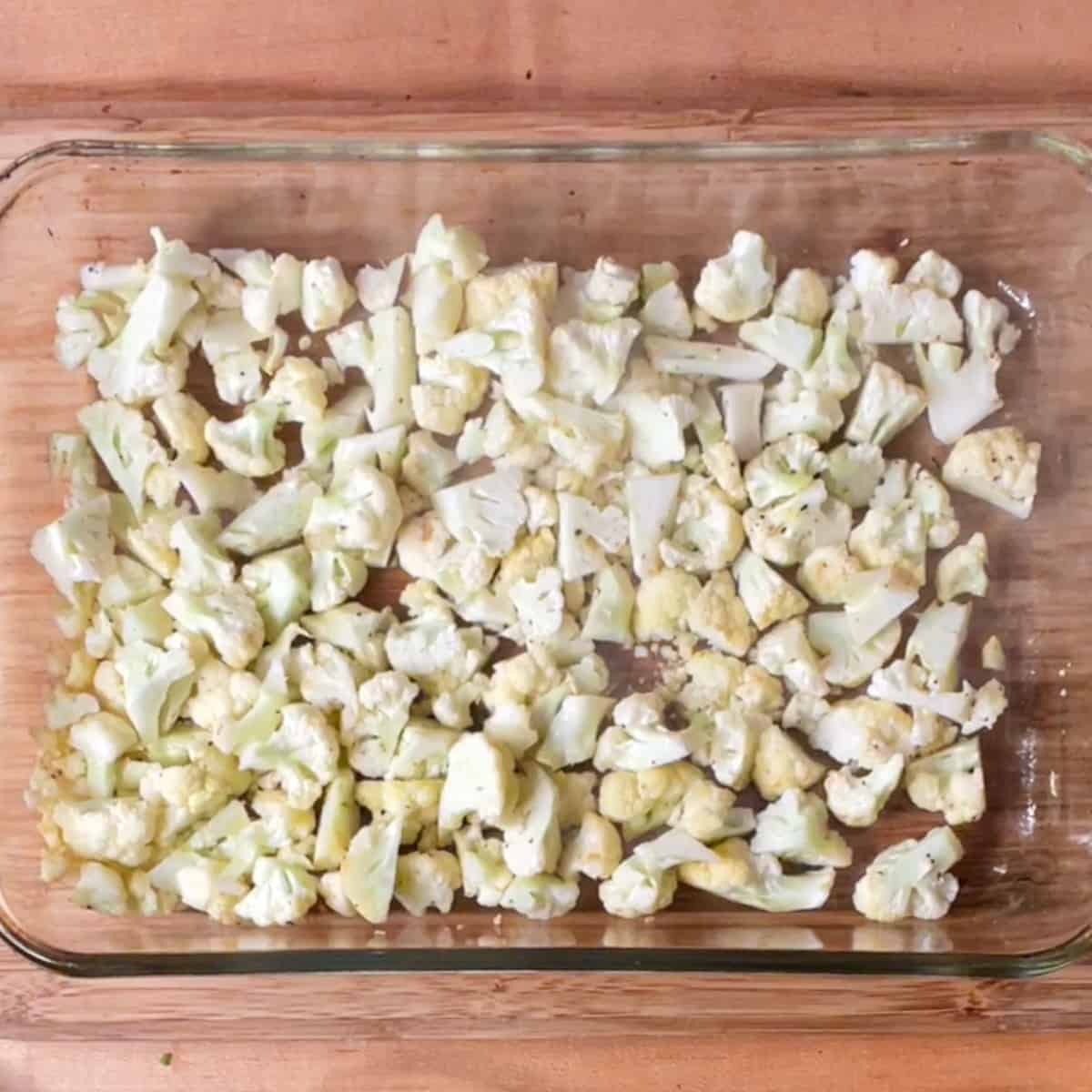 roasted cauliflower florets in a 9 by 13 baking dish.