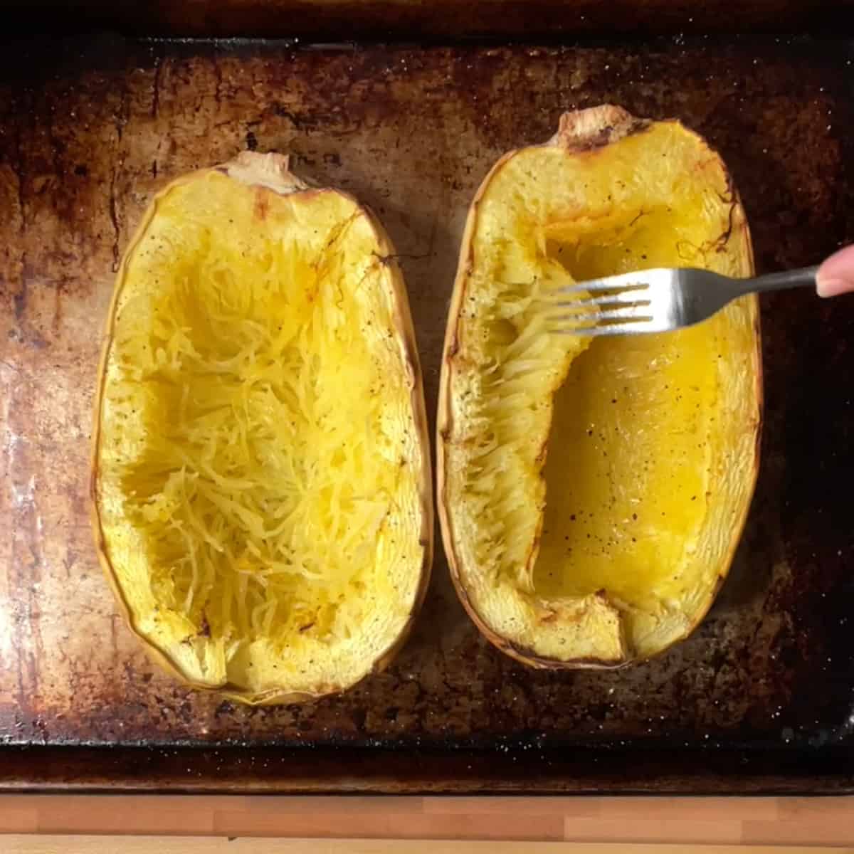 spaghetti squash after roasting showing how the strands pull away with a fork.