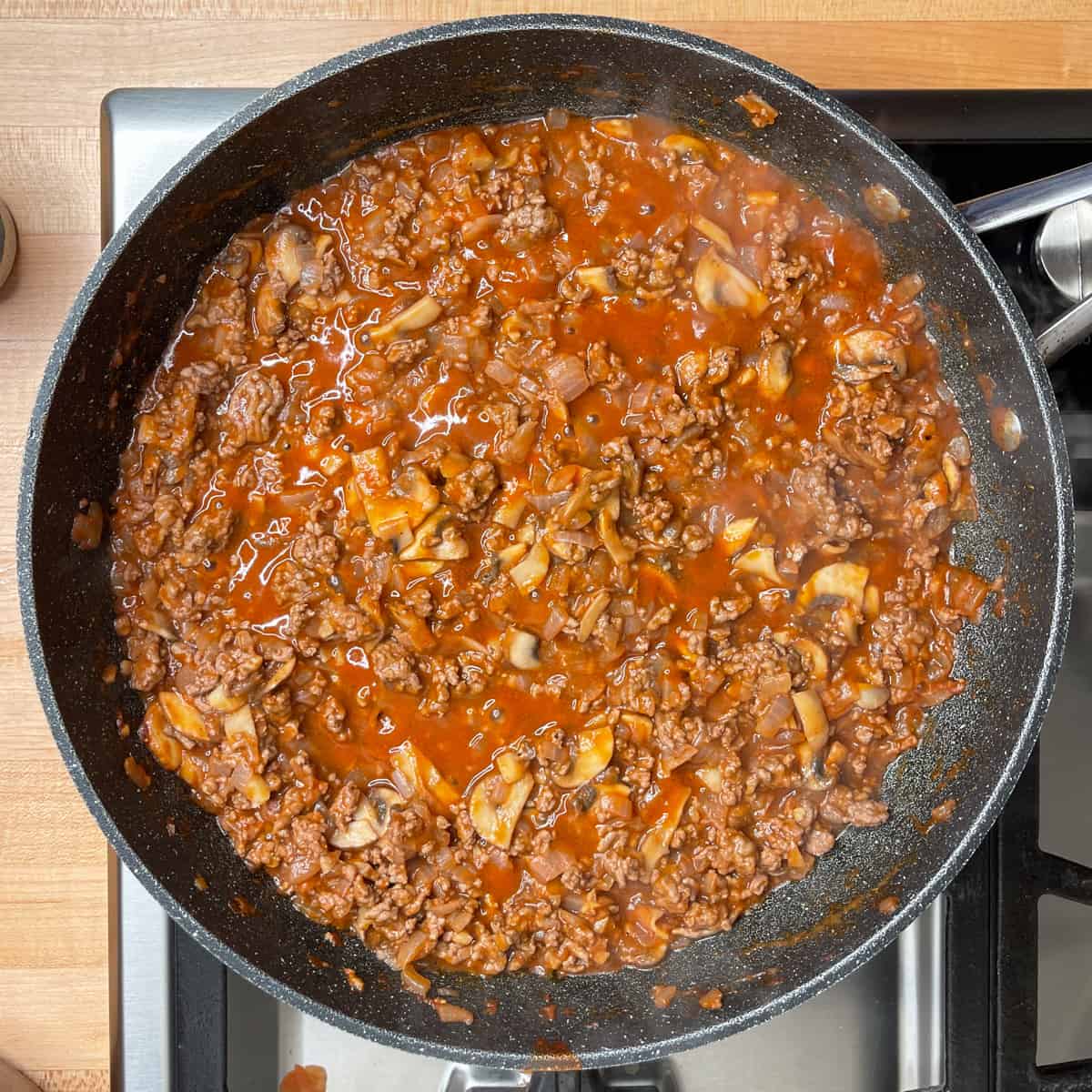 tomato sauce added to the skillet with the ground beef, onions and mushrooms. 