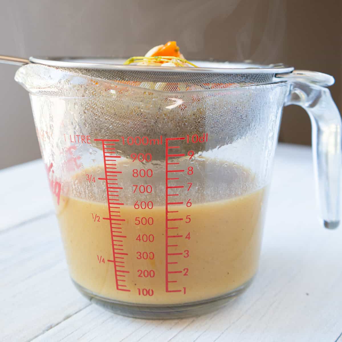 gravy strained into a large measuring cup.