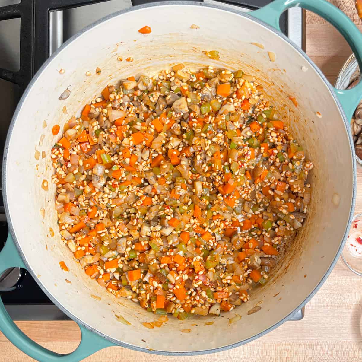 barley, spices and tomato paste added to the pot.