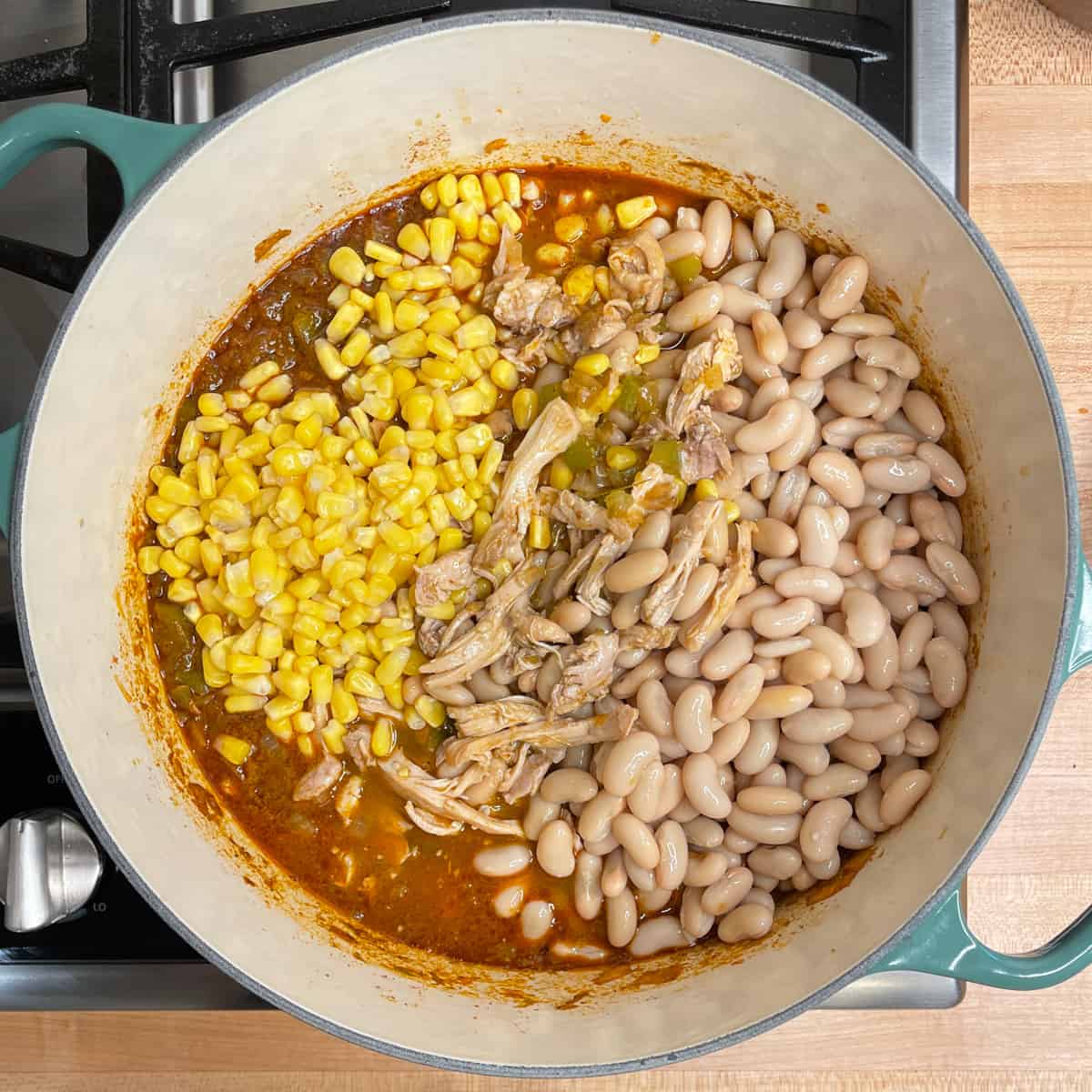 beans, chicken, and corn are added to the pot.