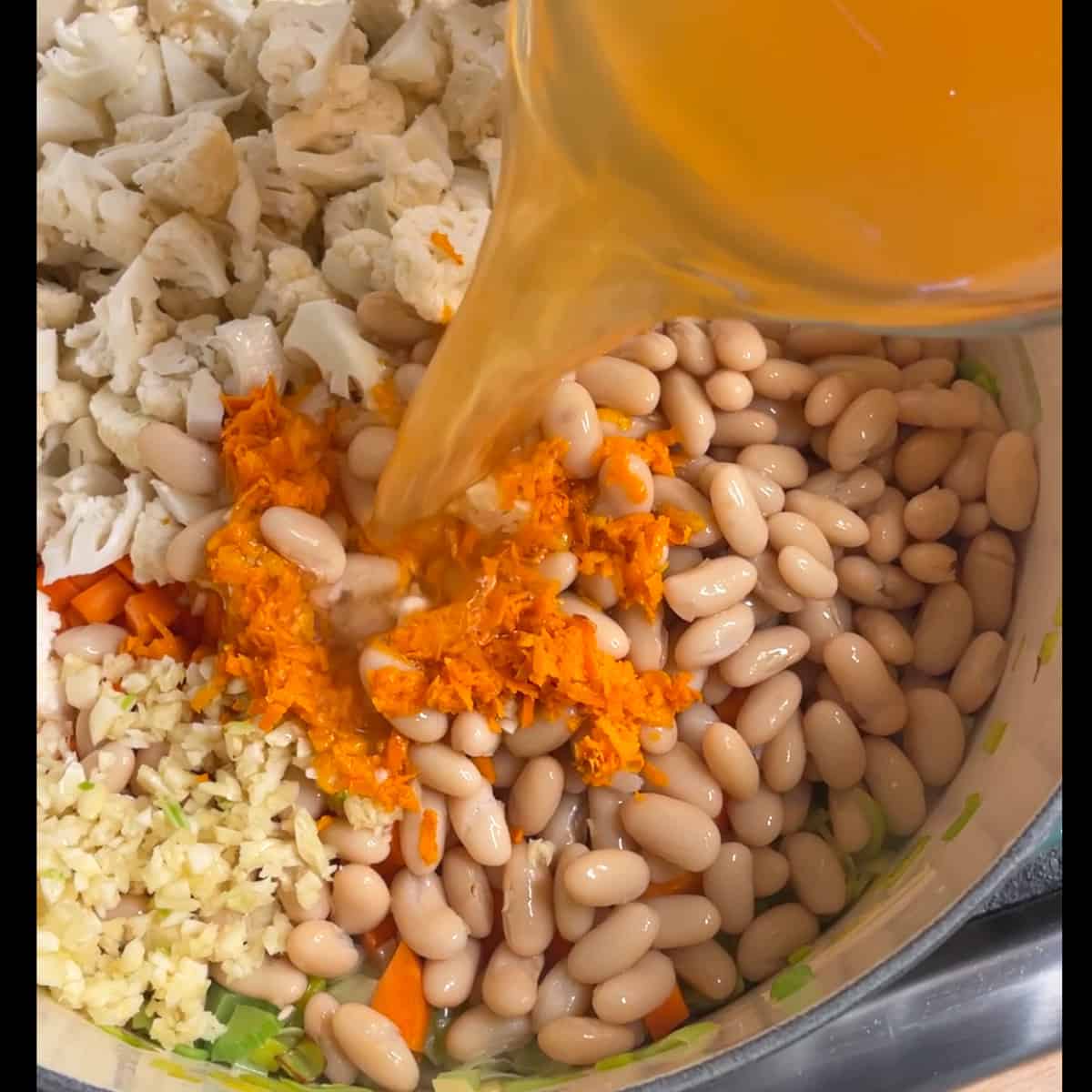 broth being added to the soup pot. 