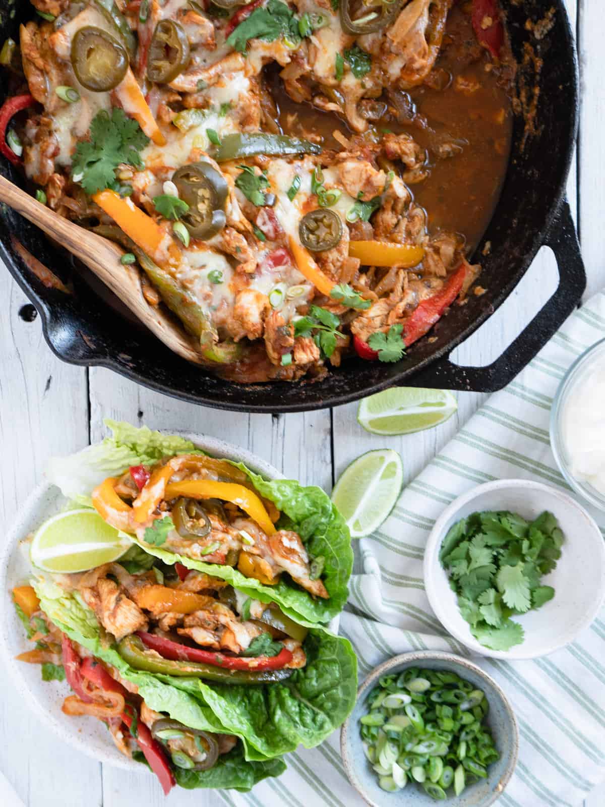 fajita casserole served in lettuce boats with the skillet on the side. 