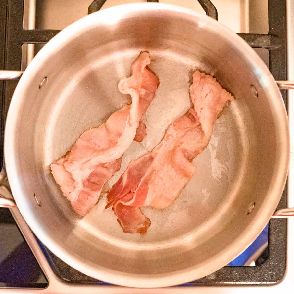 Bacon for bbq sauce cooking in a saucepan. 