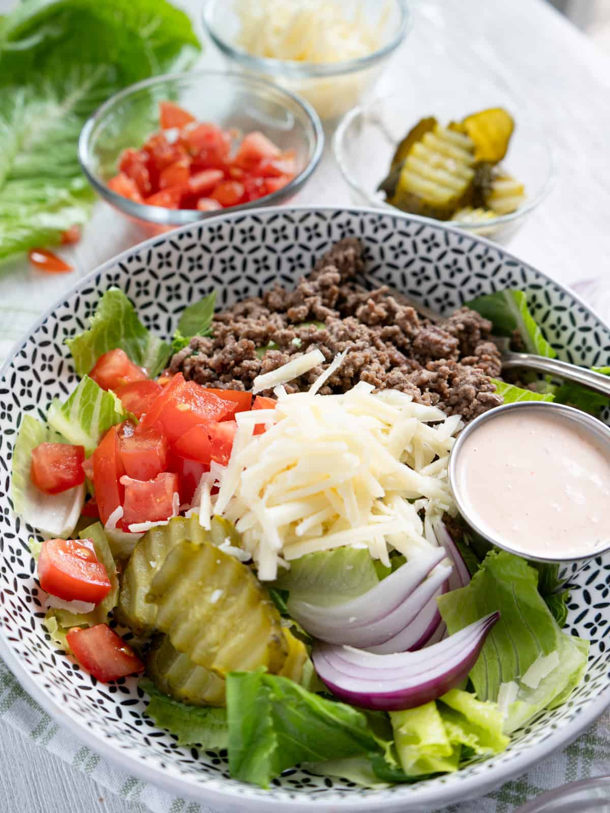 a completed burger bowl assembled with all the toppings. 