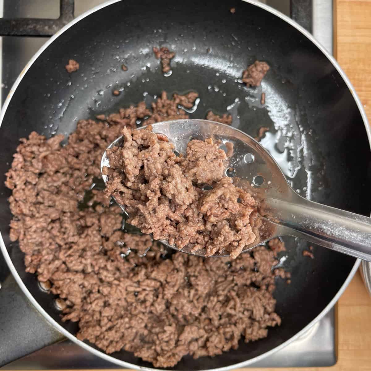 ground beef in a slotted spoon to drain off excess fat. 