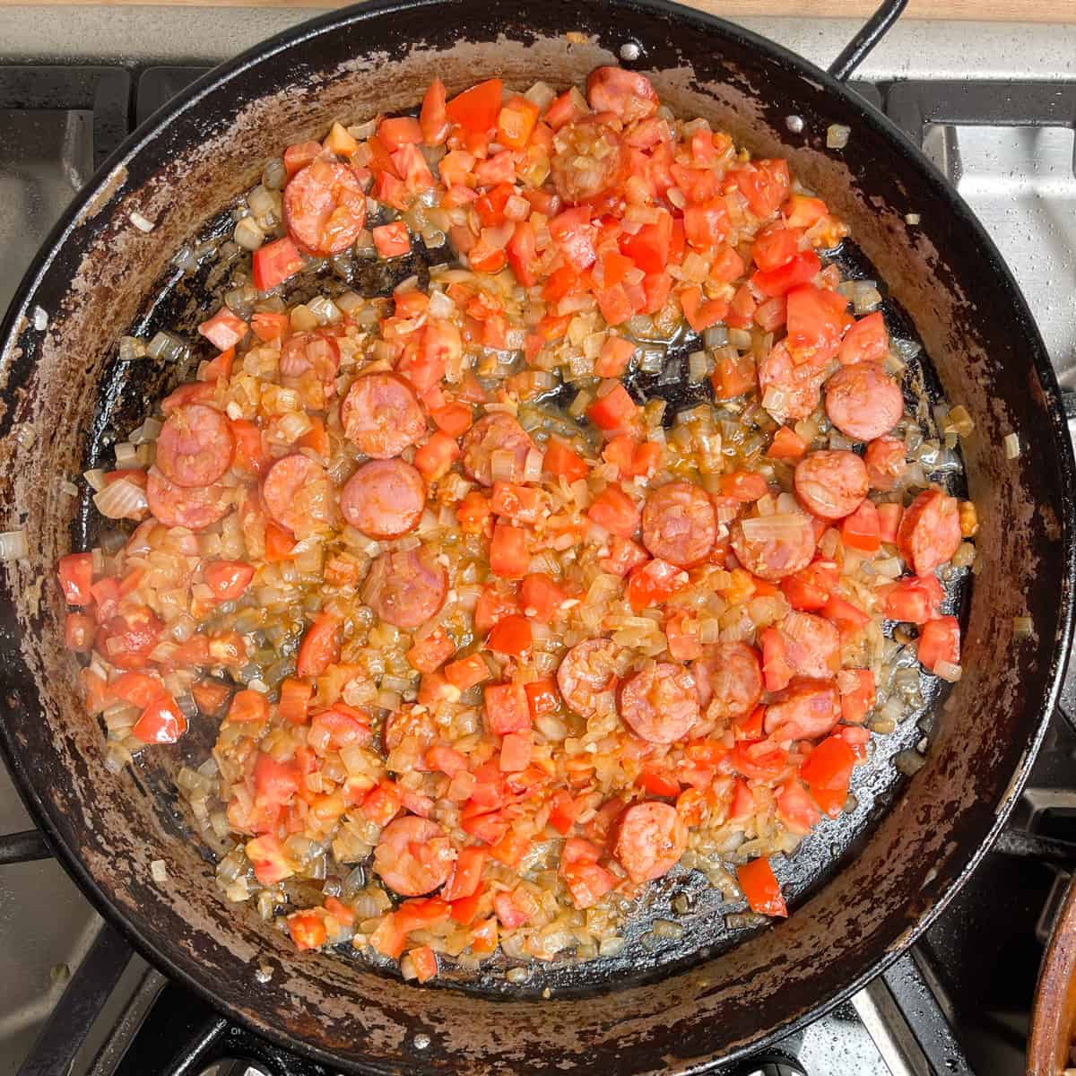 chorizo, onions, tomatoes and garlic sauteeing in a pan. 