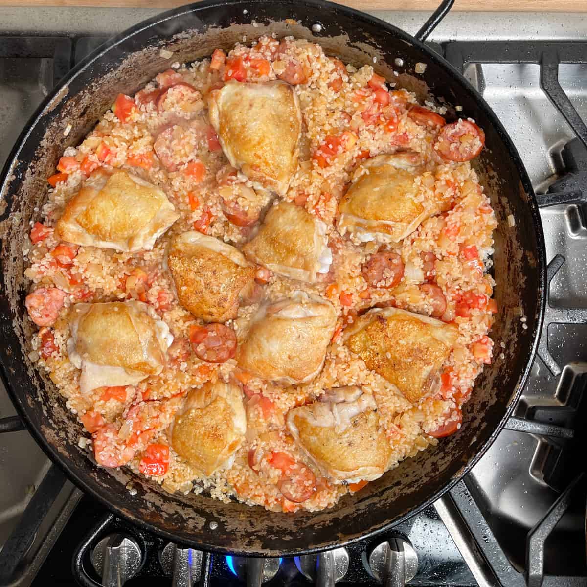 chicken is nestled into the rice and tomato mixture. 