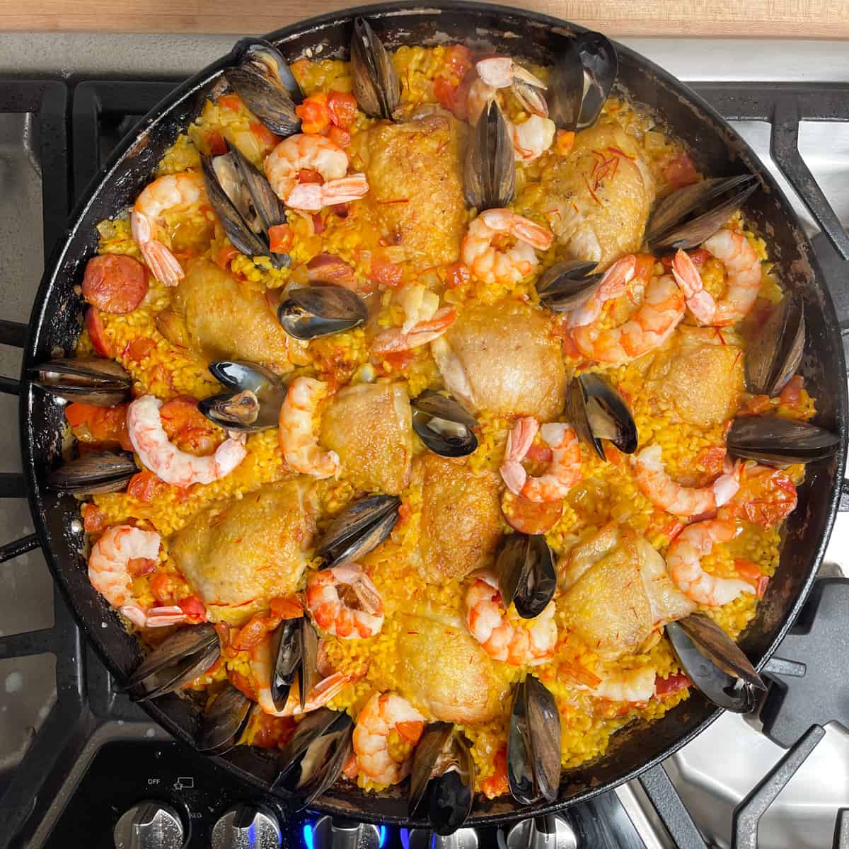 shrimp and mussels are nestled into the rice with the chicken.