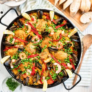 Cooking Traditional Spanish Paella In A Big Iron Cast Pan Stock