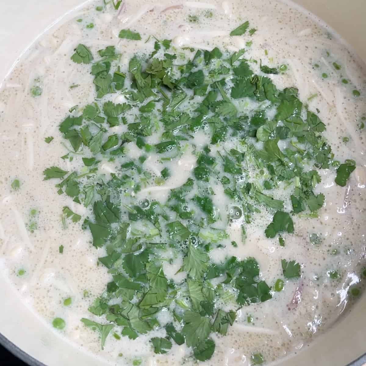 fresh cilantro added to creamy coconut soup. 