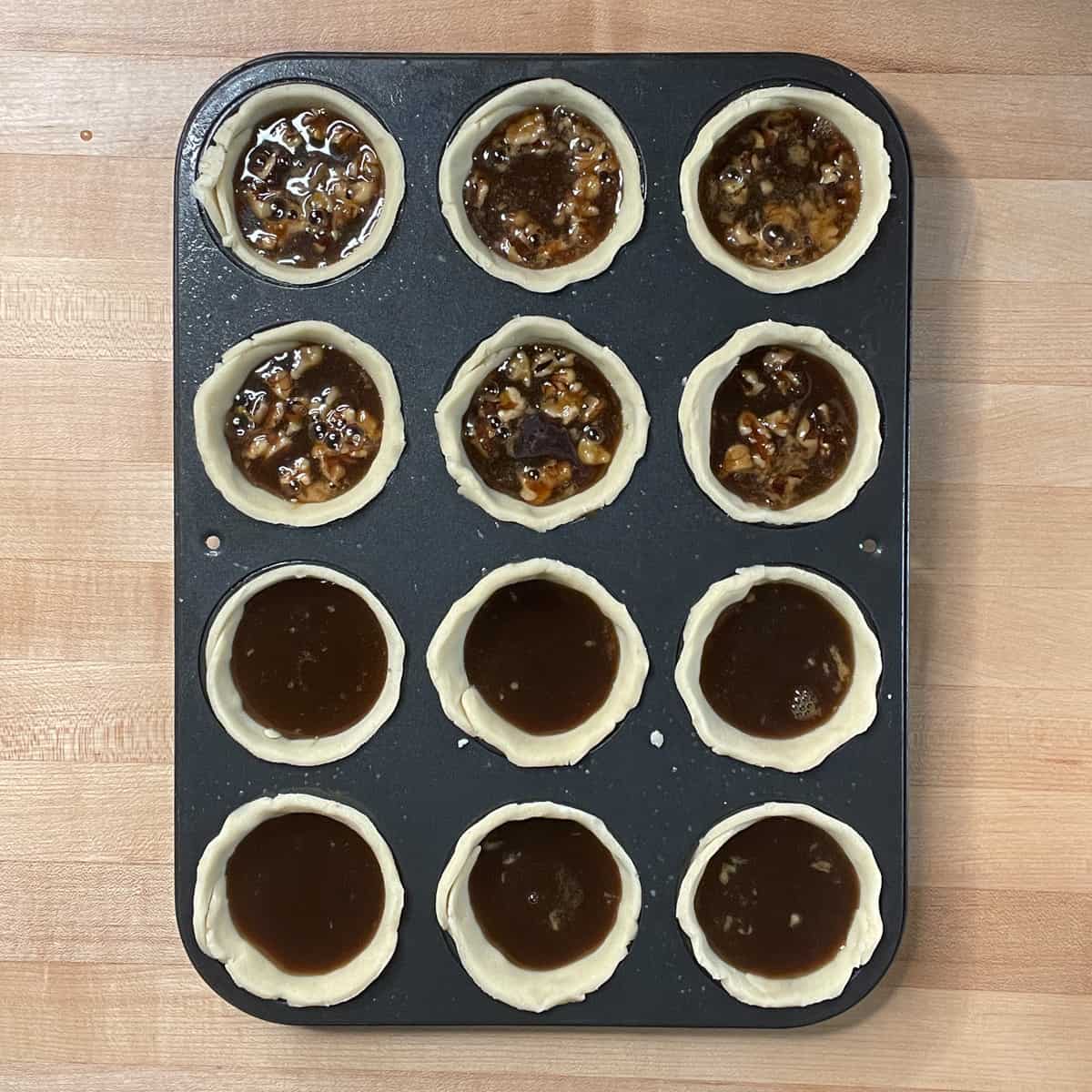 tart shells filled with filling, 6 with nuts, before baking.