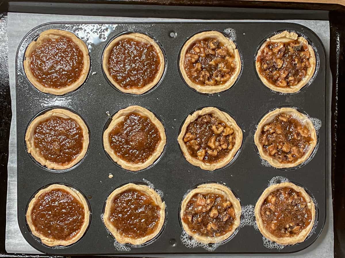 baked butter tarts in muffin tin after baking.
